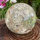 Overhead view of Ocean Jasper polished sphere, often paired with practices around Emotional Healing.