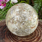 Bottom side of Ocean Jasper polished sphere, from Madagascar, showing characteristic color.