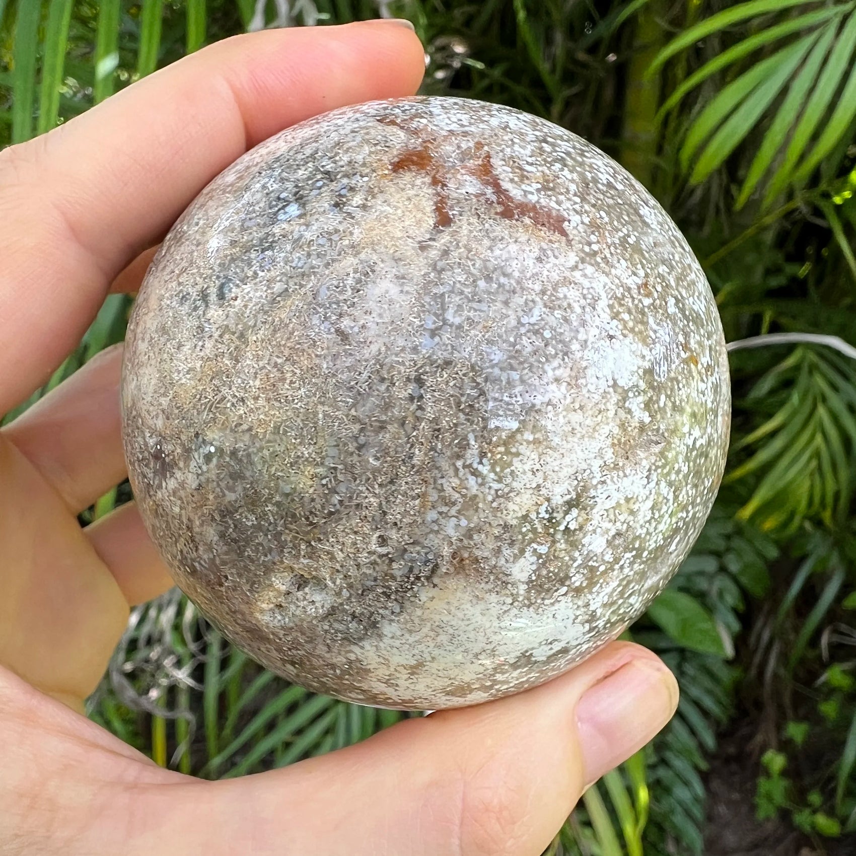 Scale comparison of Ocean Jasper stone, linked to Stress Relief, captured in soft, even lighting.