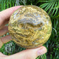 Edge view of Ocean Jasper polished sphere, sourced from Sofia, Madagascar, showing color depth.