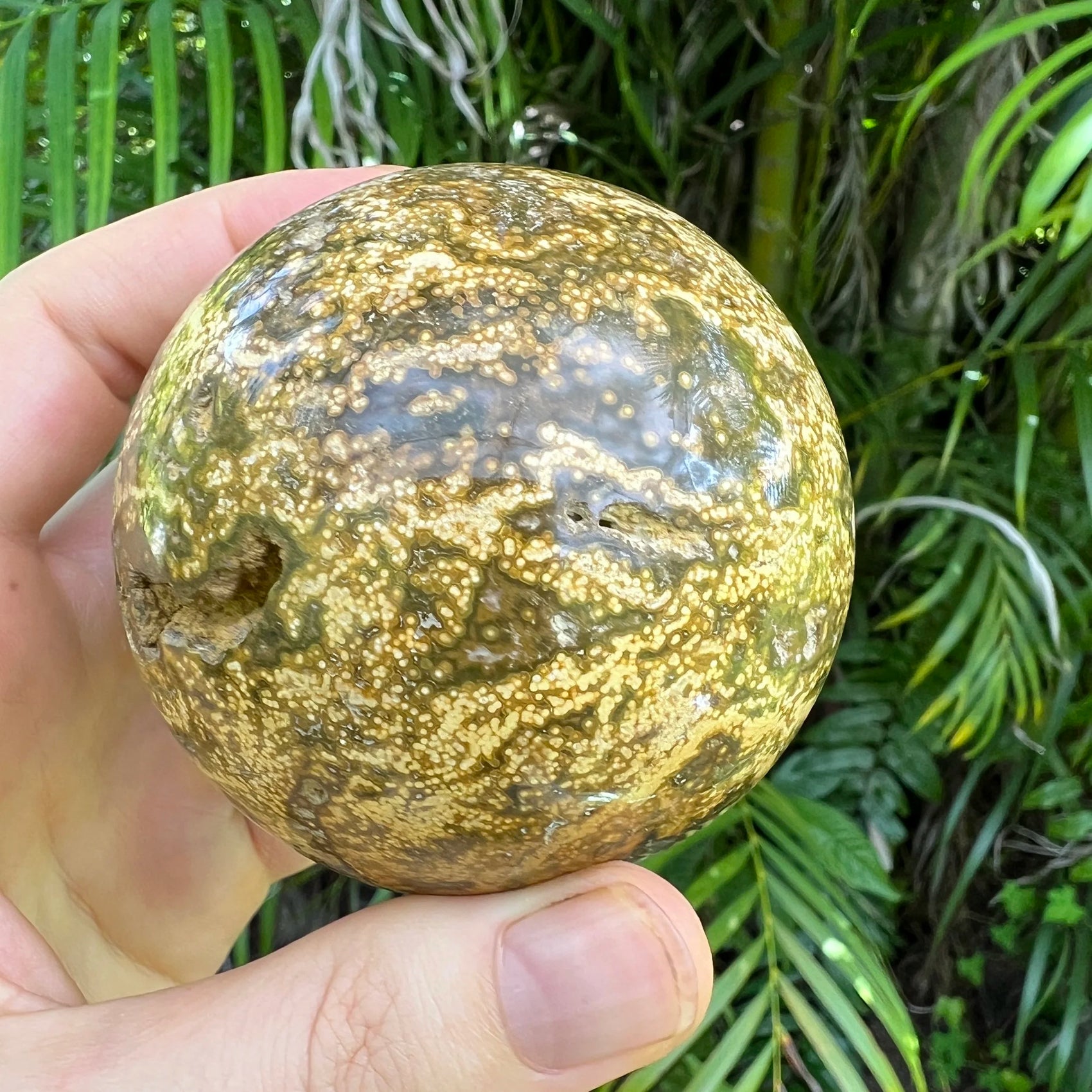Bird's-eye view of Grade AA Ocean Jasper polished sphere, associated with Emotional Healing, sourced from Madagascar.