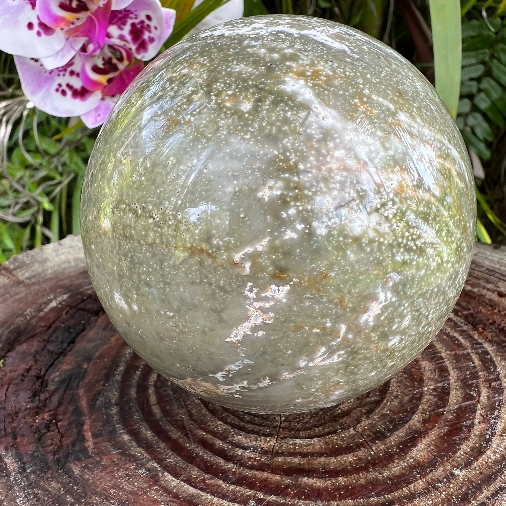 Overhead view of Grade AA Ocean Jasper polished sphere, from Madagascar, often kept for Emotional Healing and Stress Relief.