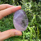 Macro view of Amethyst palm stone, showing matte finish, turned to for Stress Relief and Sleep.
