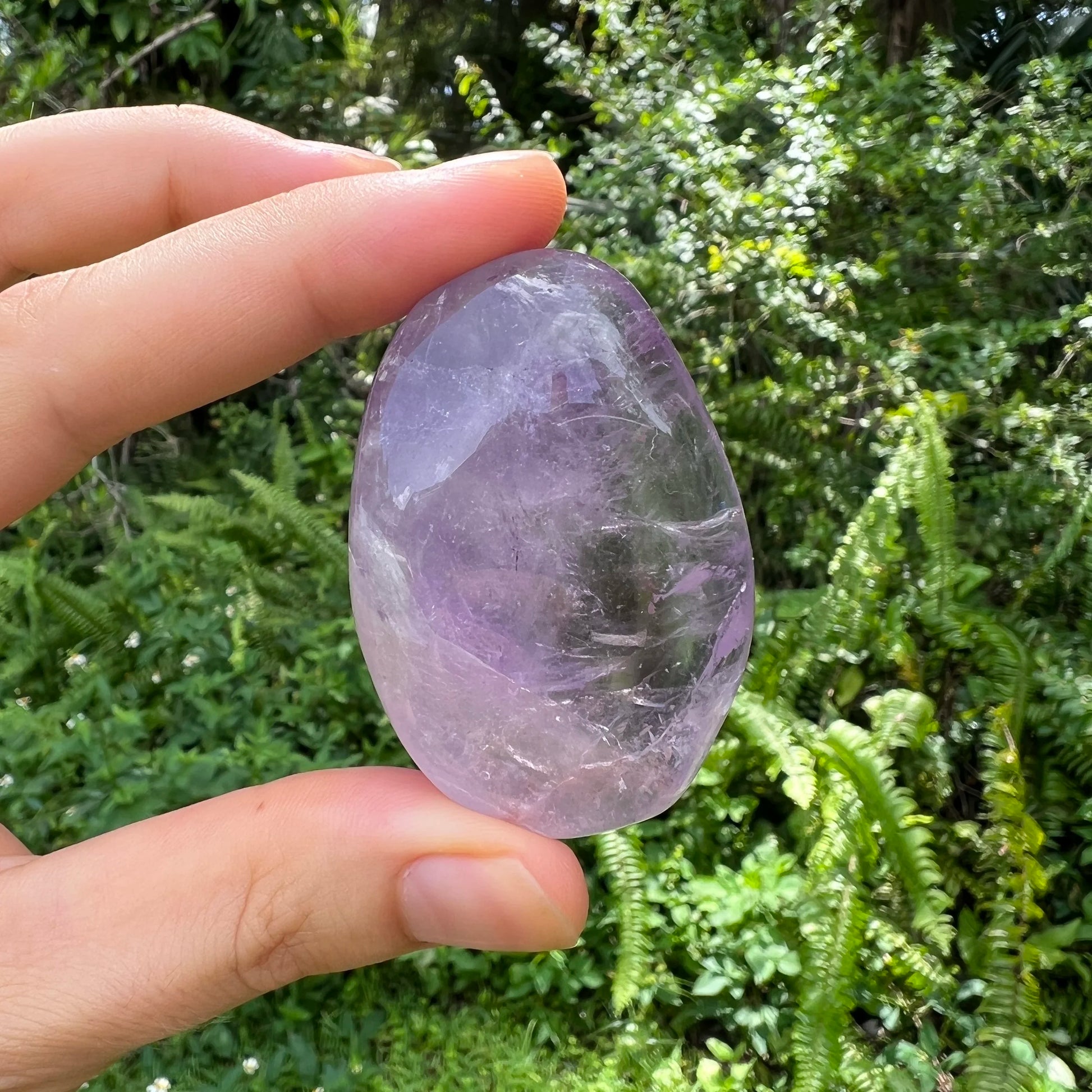 Macro view of Amethyst palm stone, showing matte finish, turned to for Stress Relief and Sleep.