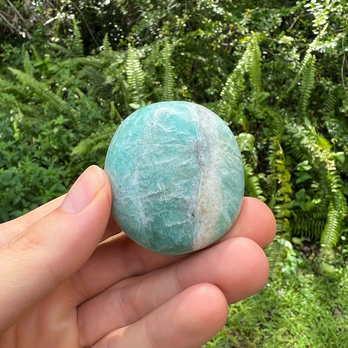 Detail shot of Grade A Amazonite palm stone under natural light