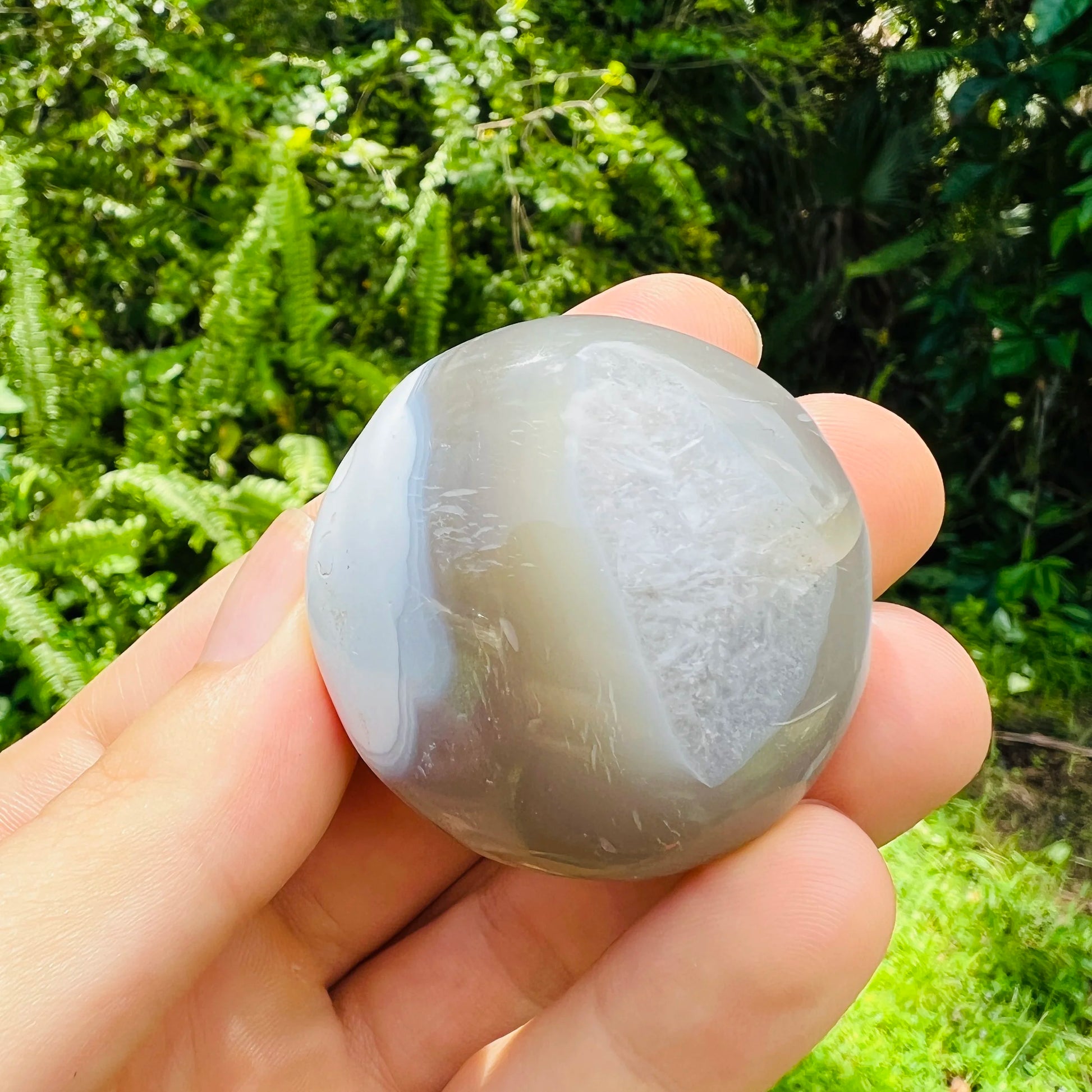 In context of an Orca Agate palm stone, from Sofia, Madagascar, shown for size reference.