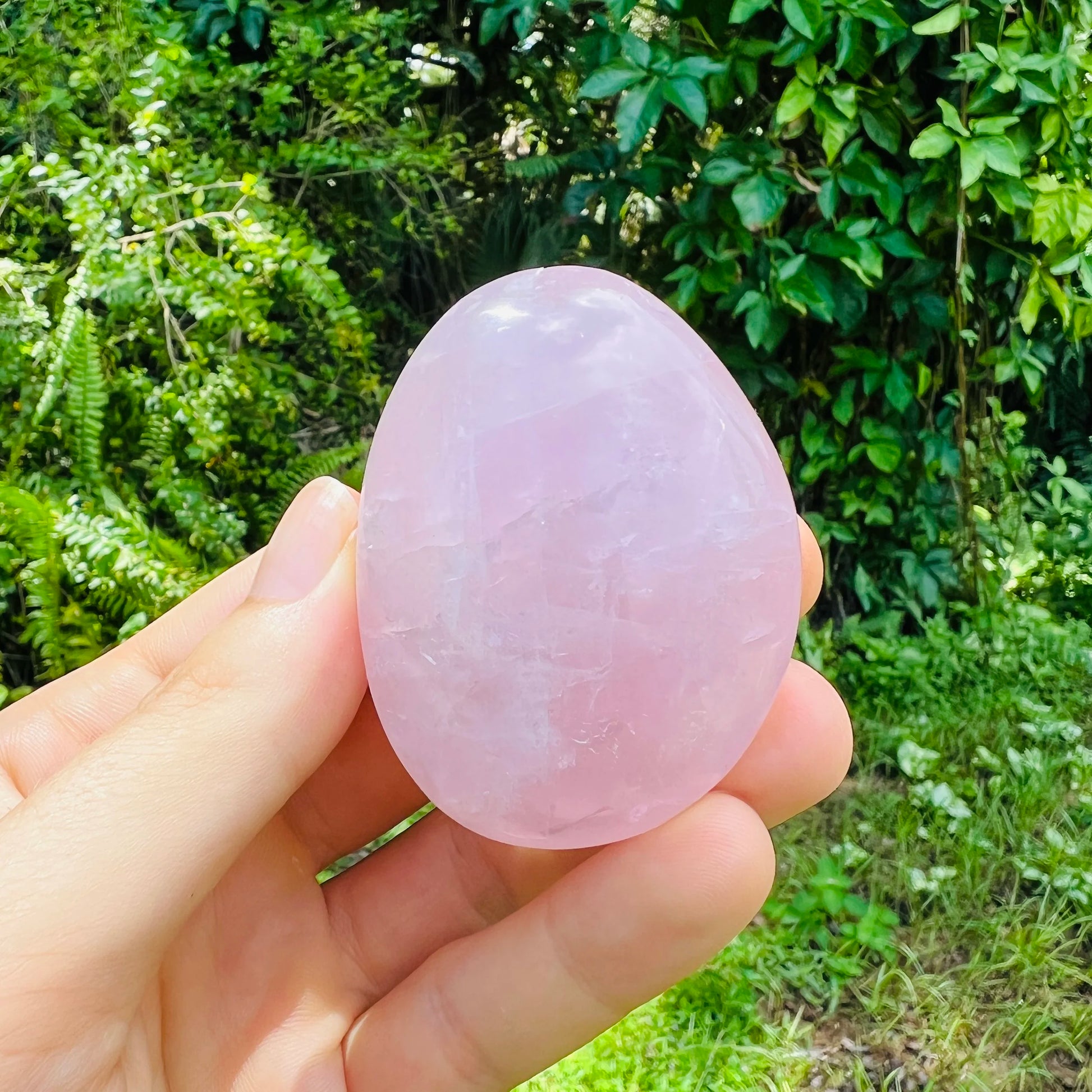 Aerial view of Rose Quartz palm stone, hand-selected from Alaotra-Mangoro, Madagascar, showing natural sheen.