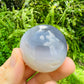 Back view of Grade AA Orca Agate palm stone showing natural surface