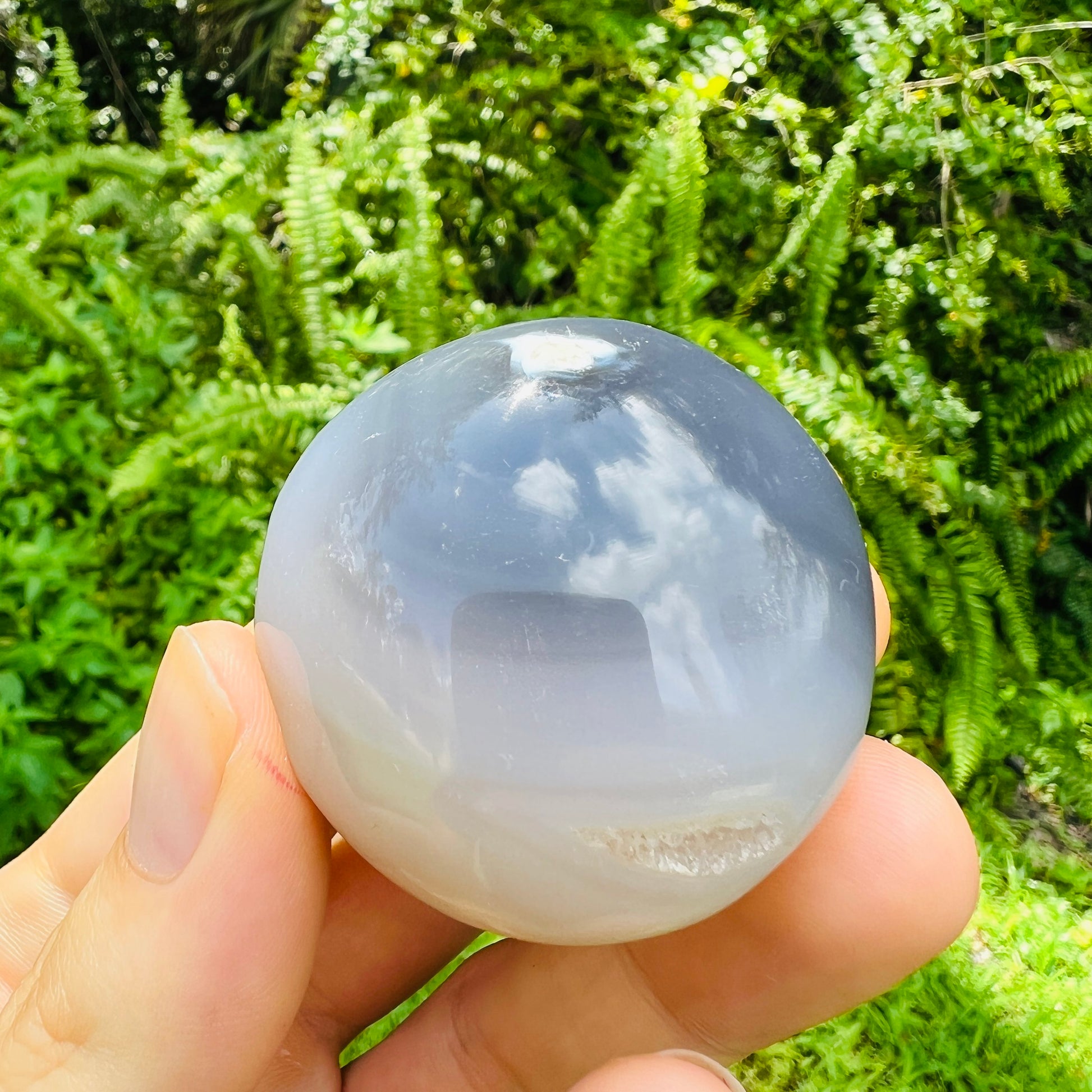 Back view of Grade AA Orca Agate palm stone showing natural surface