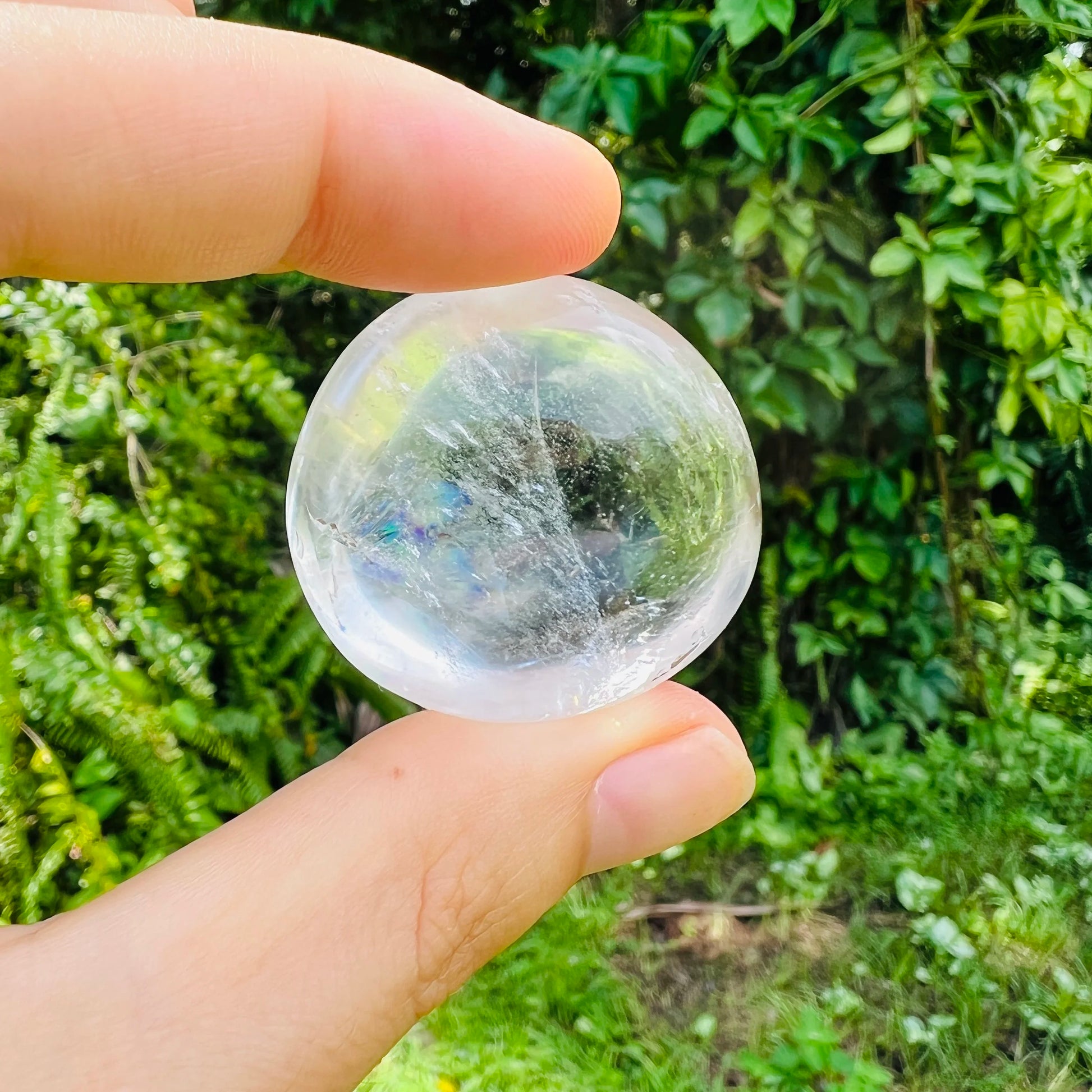 Held in hand, a single Clear Quartz palm stone from Vakinankaratra, Madagascar.
