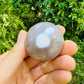 Detail shot of Grade AA Orca Agate palm stone under natural light