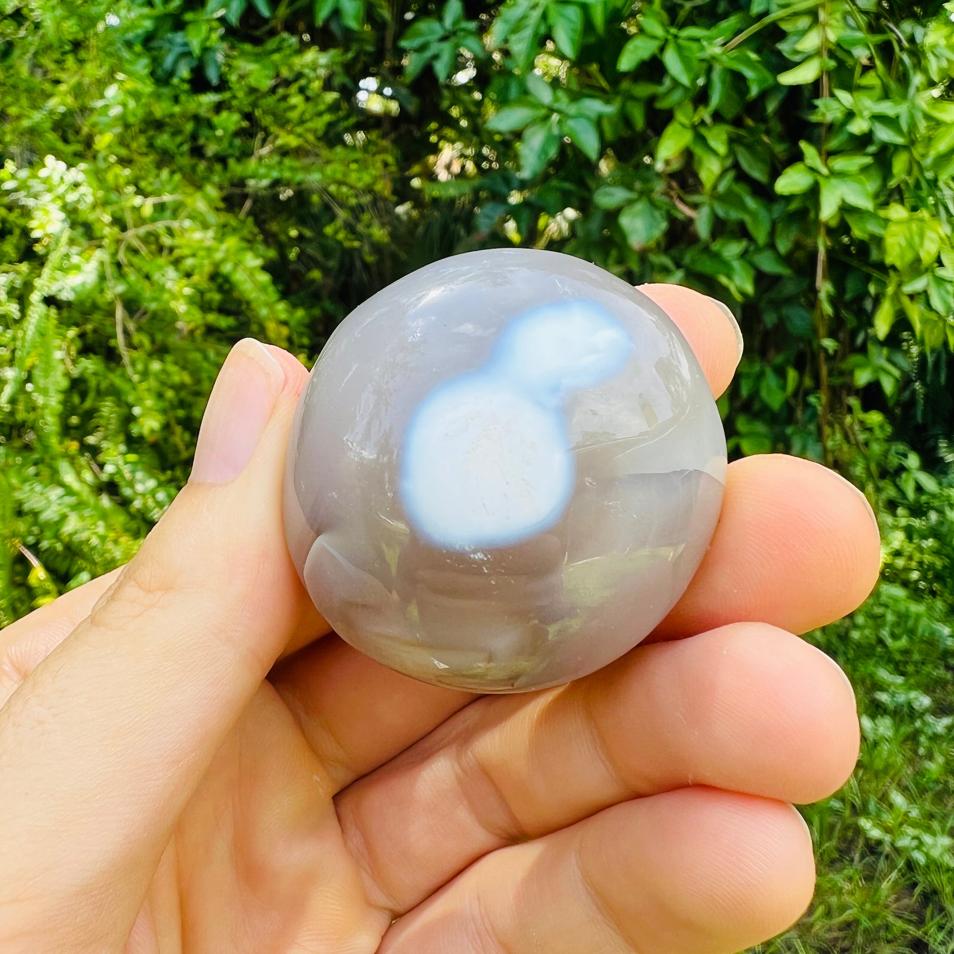 Detail shot of Grade AA Orca Agate palm stone under natural light