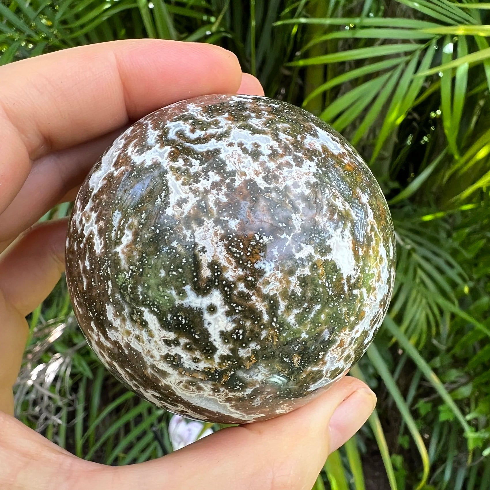 Detail shot of Grade AA Ocean Jasper sphere under natural light