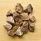 Sideways view of Brown Aragonite raw stone, showing earthy tone, from Peru.