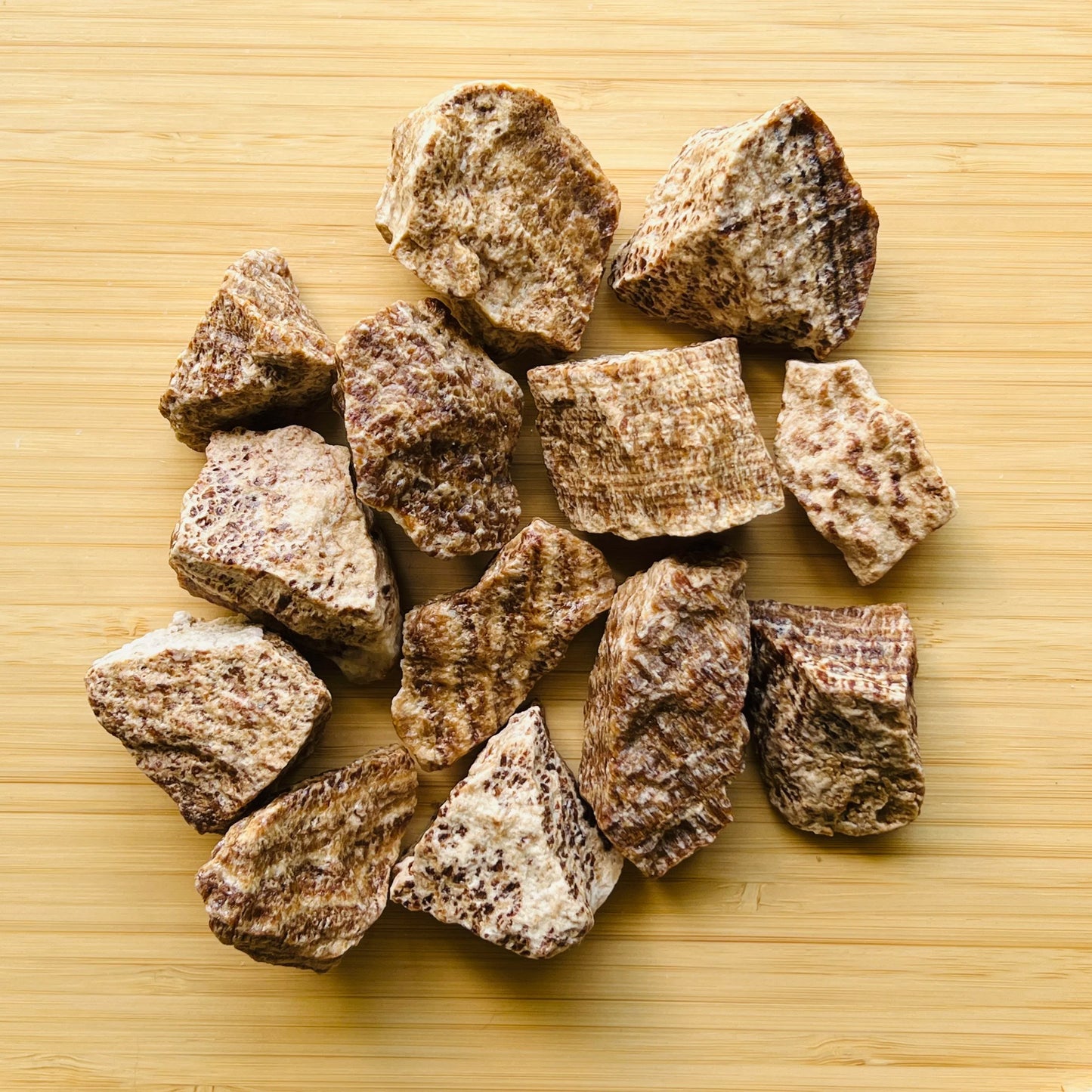 Sideways view of Brown Aragonite raw stone, showing earthy tone, from Peru.