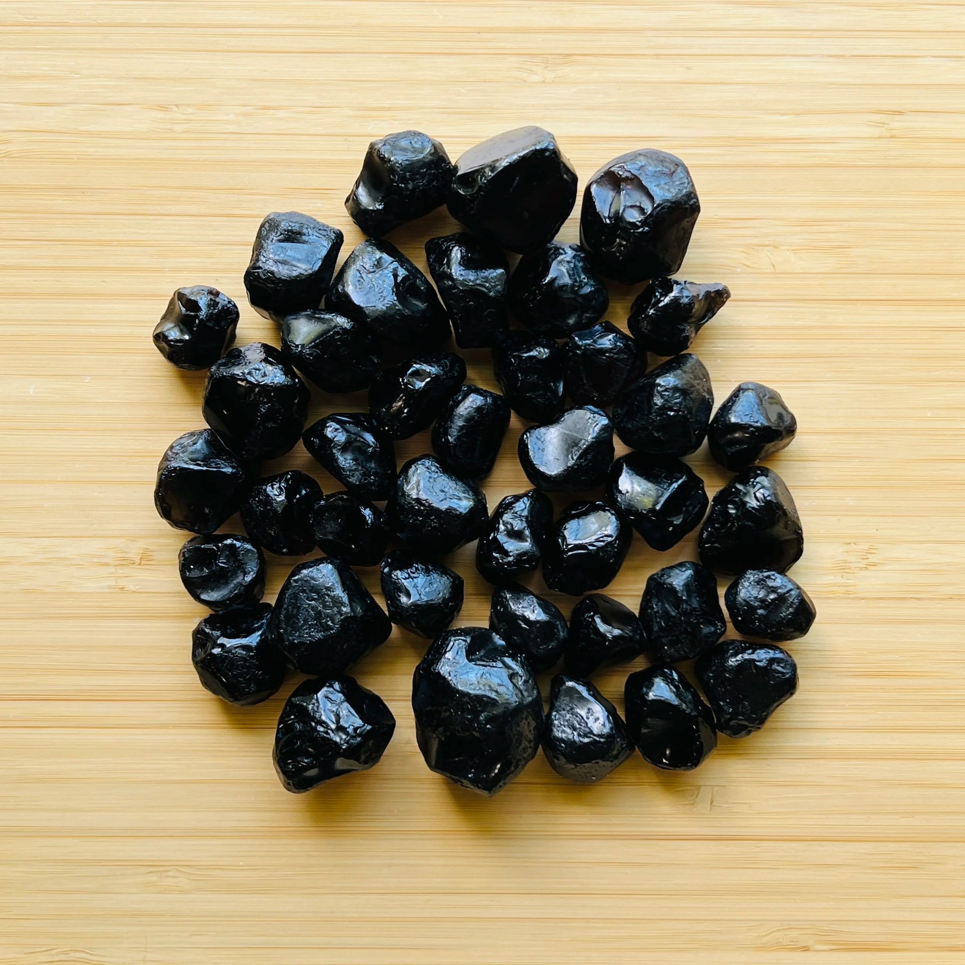 Tight crop of Grade AA Apache Tear raw stone, United States-sourced.