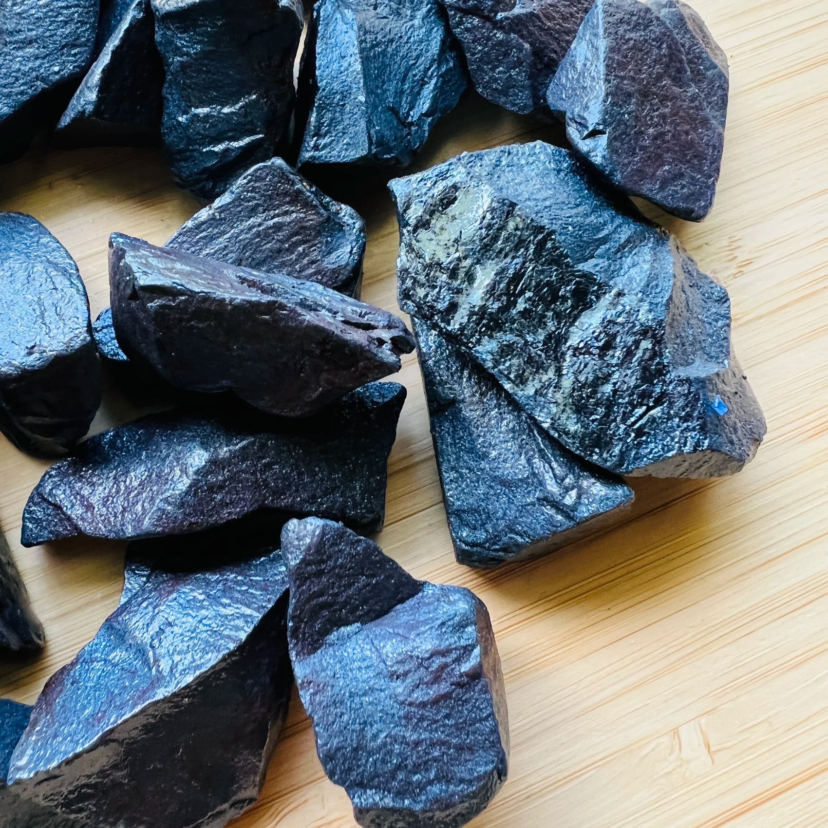 Edge view of Hematite raw stone, Brazil-sourced, kept close for Grounding.