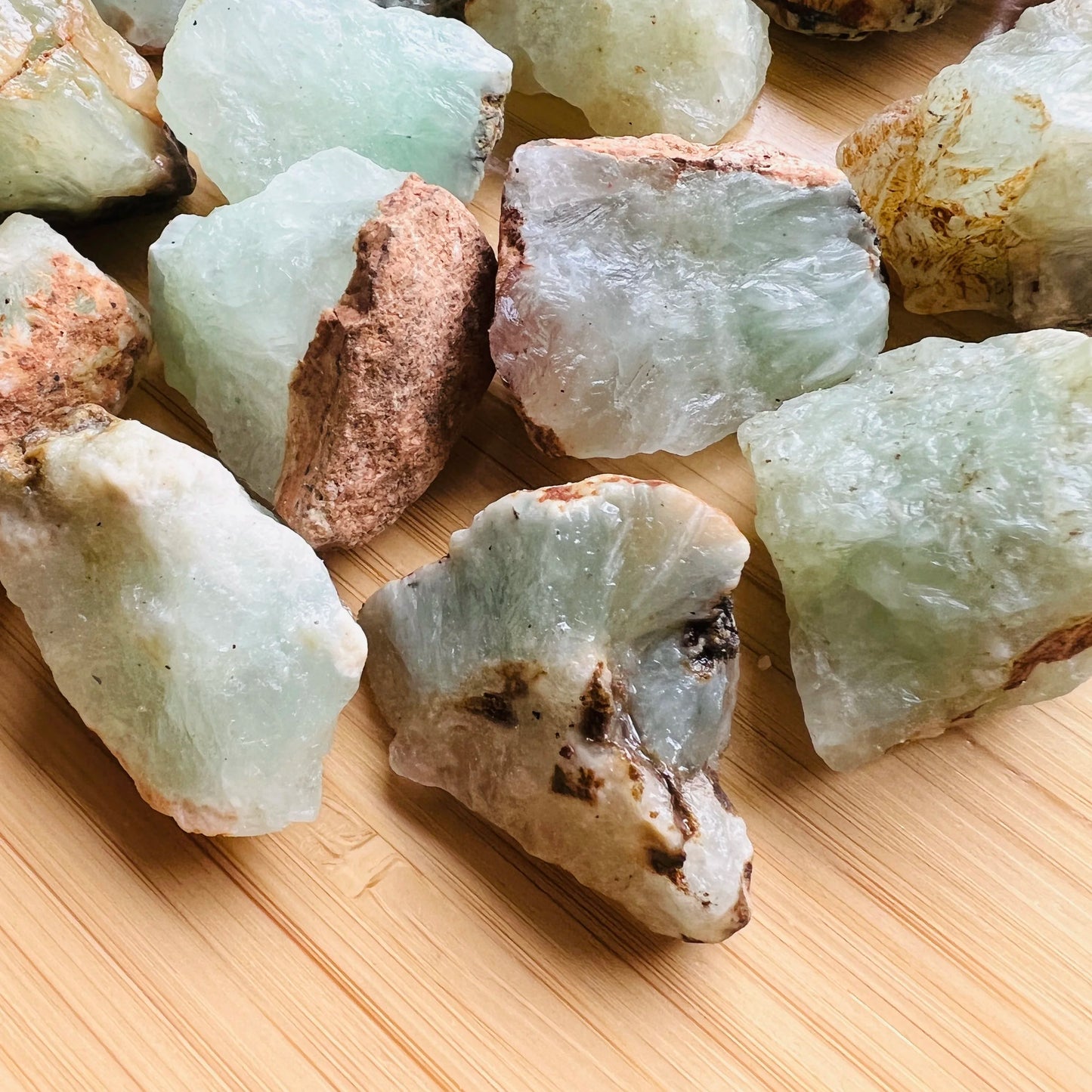 Looking down on Grade A Prehnite raw stone, hand-selected from Kunene, Namibia, showing earthy tone.