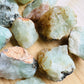 Alternate angle of green Prehnite raw stone, showing characteristic finish, from Kunene, Namibia.