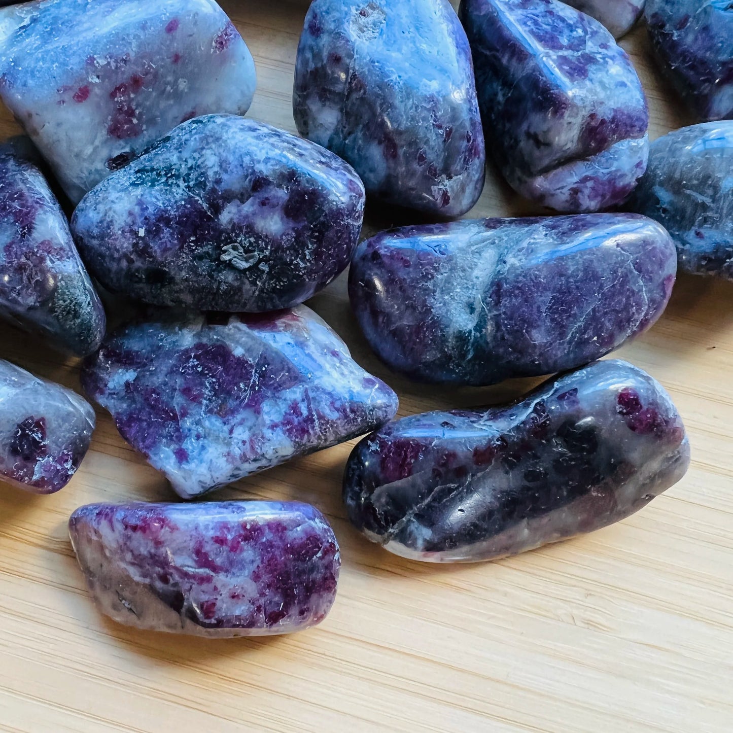 Side perspective of Pink Tourmaline tumbled stone, sourced from Madagascar, kept near for Love.