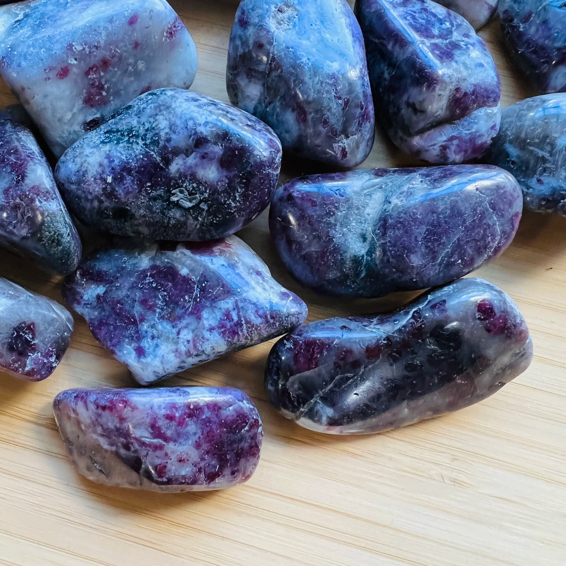 Side perspective of Pink Tourmaline tumbled stone, sourced from Madagascar, kept near for Love.