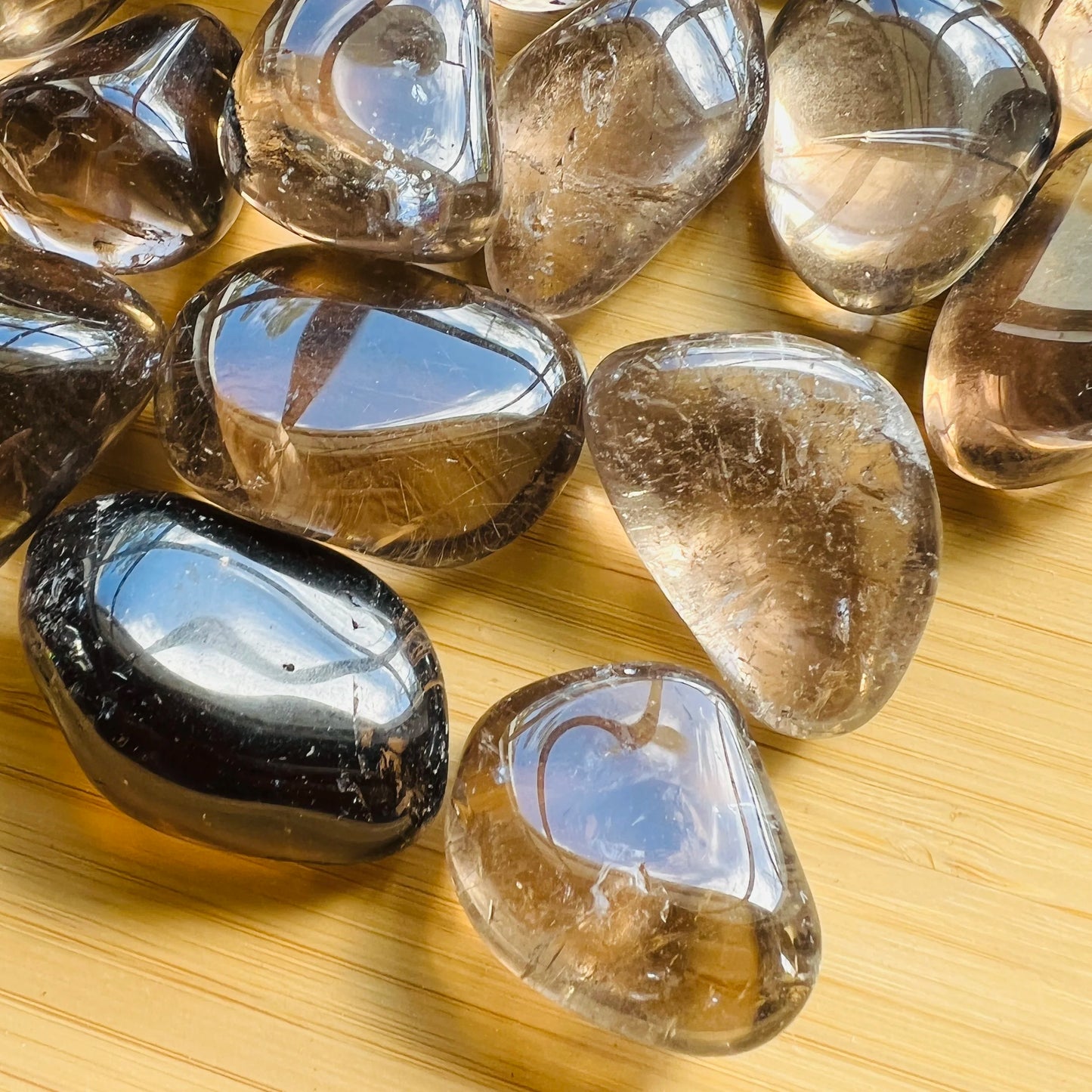 Overhead angle of Smoky Quartz tumbled stone, showing subtle veining.