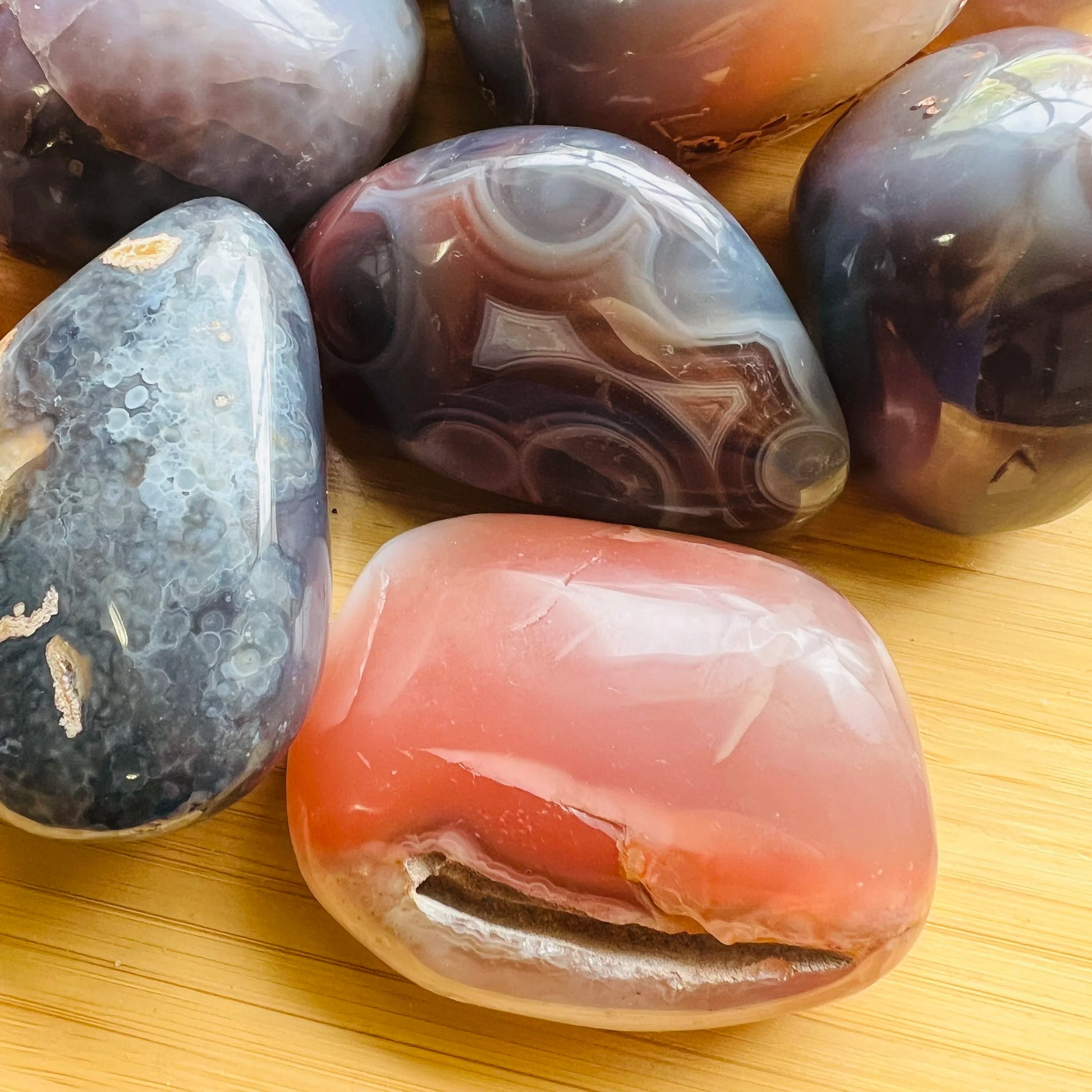 Detail of Red Agate palm stone, showing natural inclusions, often paired with practices around Grounding.