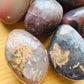 Side profile of Red Agate palm stone, to support Grounding.