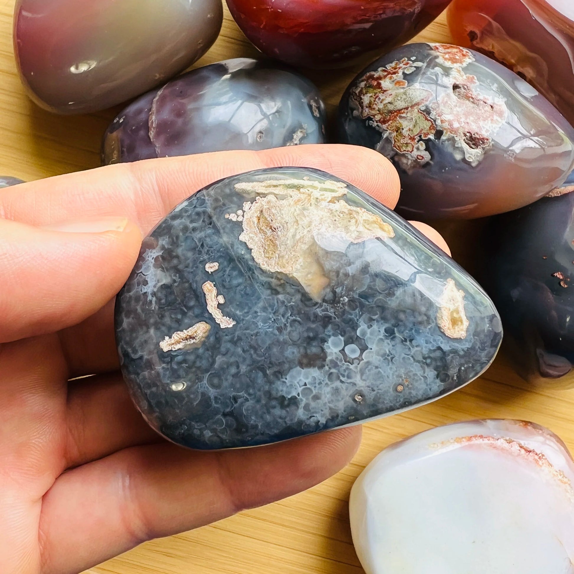 Composed shot of Red Agate palm stone, from Matabeleland South Province, Zimbabwe, often kept for Protection, shown for size reference.