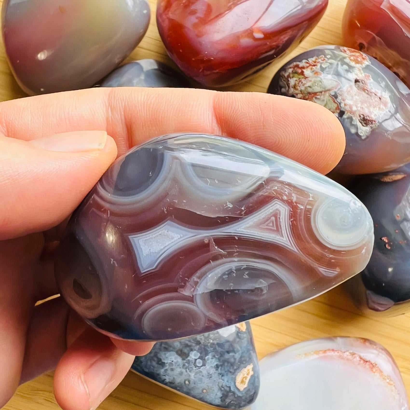 Back view of Grade AA Red Agate palm stone showing natural surface