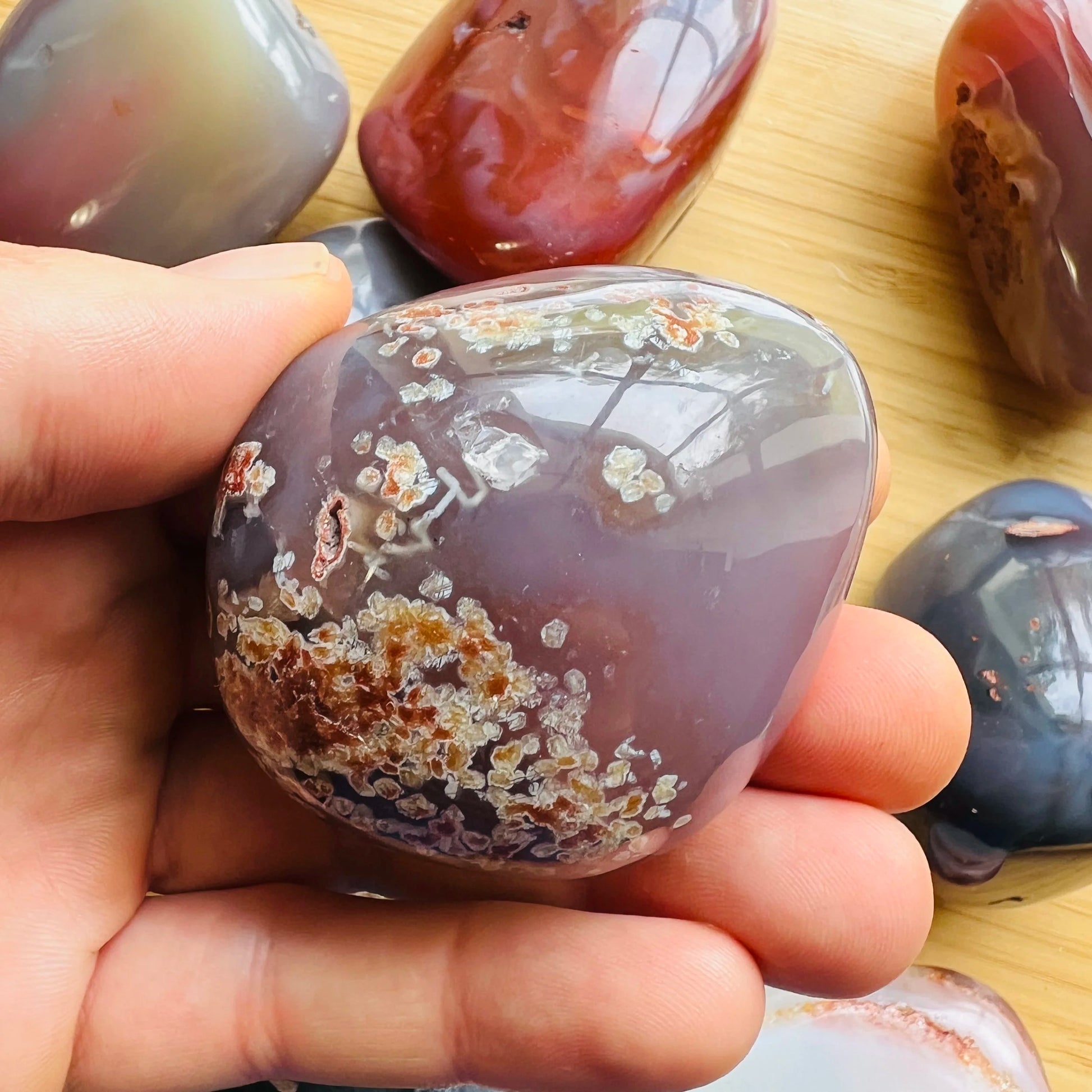 Detail shot of Grade AA Red Agate palm stone under natural light