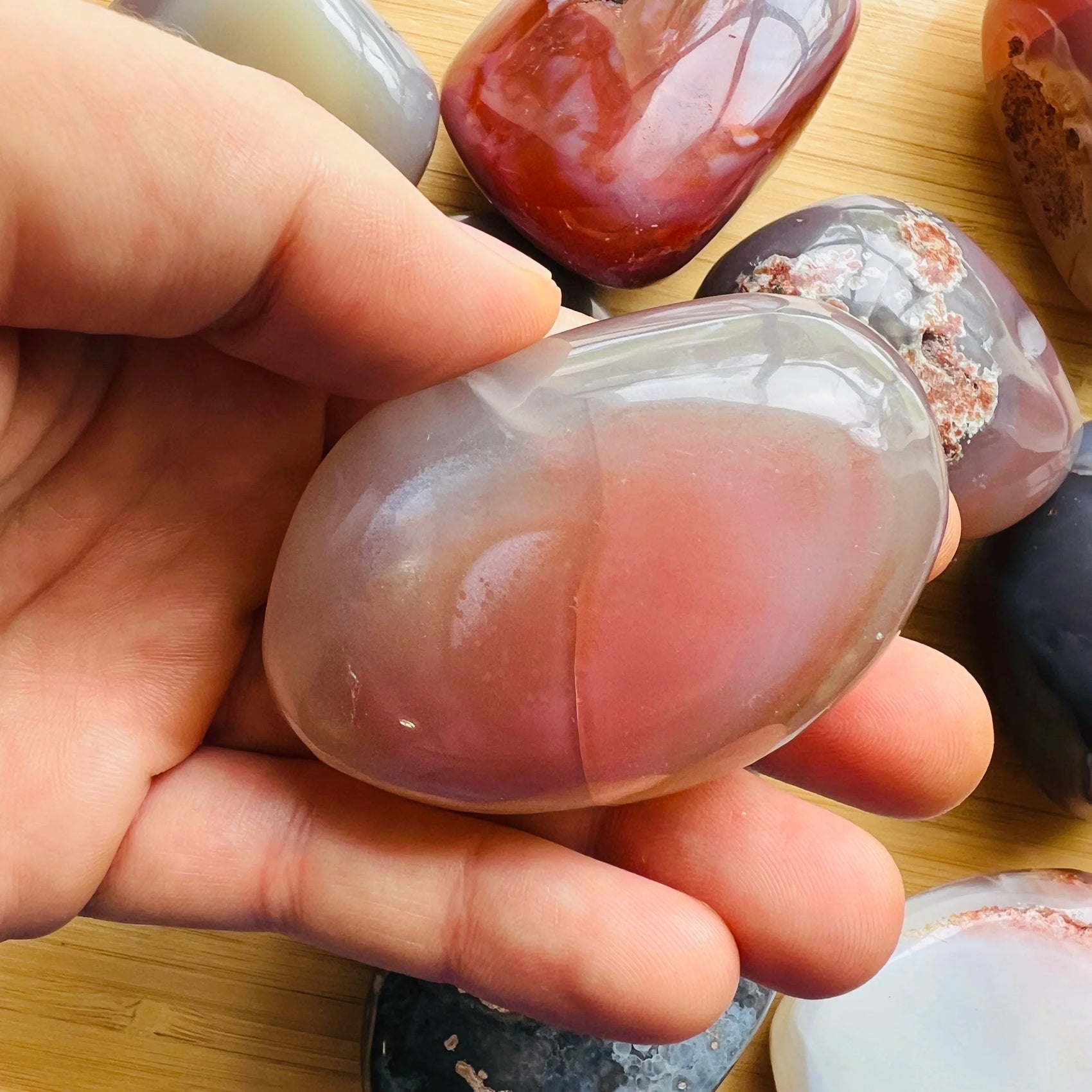 Full profile of Grade AA Red Agate palm stone ready to ship from Beyond Bohemian