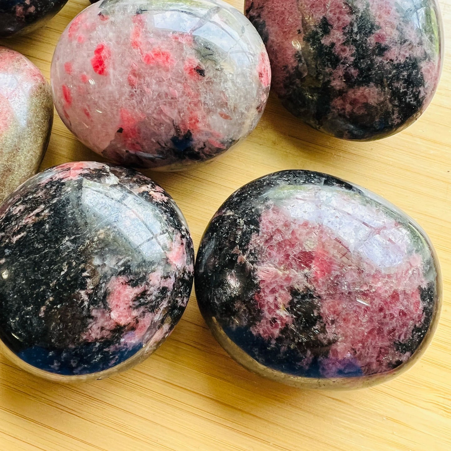 Full profile of Grade AA Rhodonite palm stone ready to ship from Beyond Bohemian