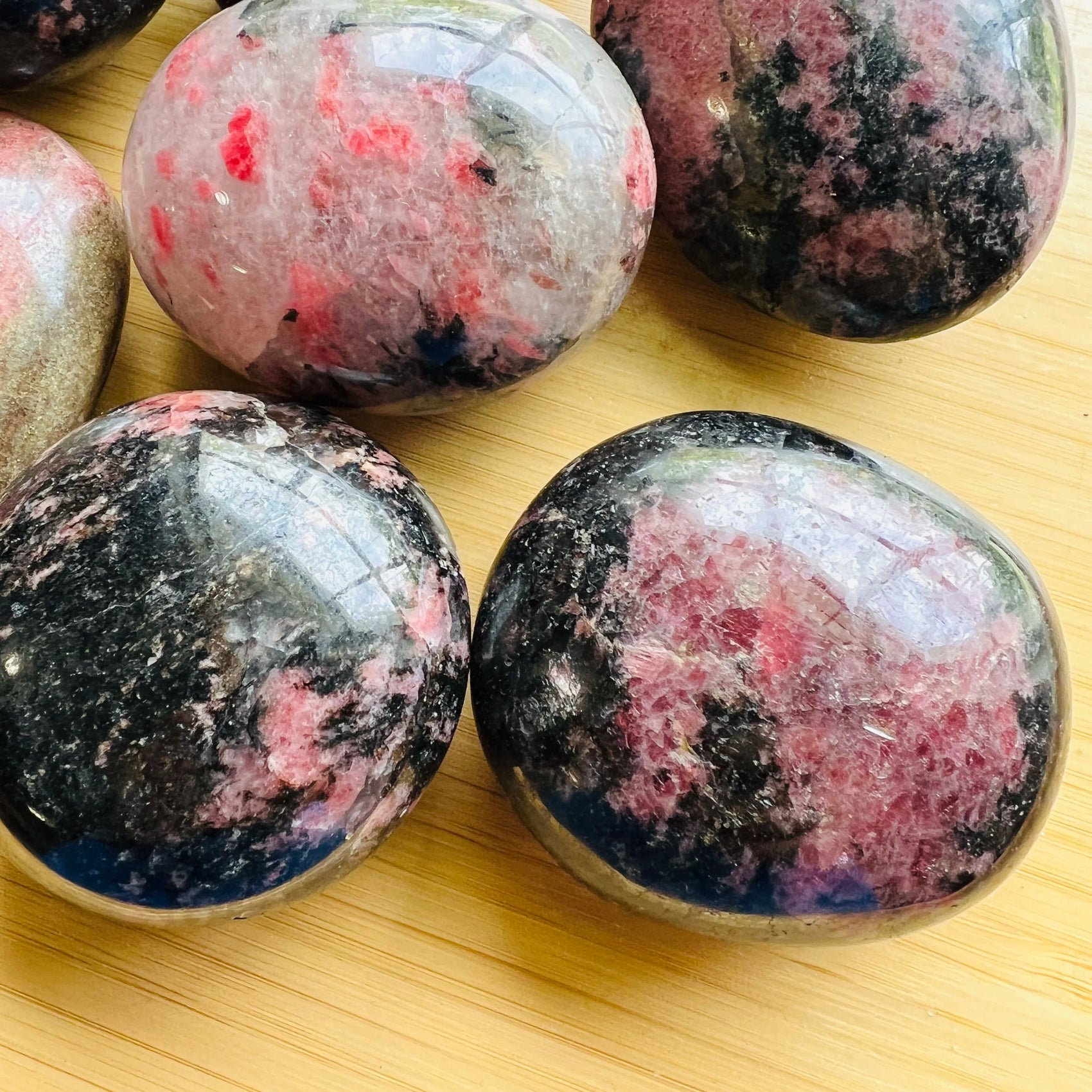 Full profile of Grade AA Rhodonite palm stone ready to ship from Beyond Bohemian