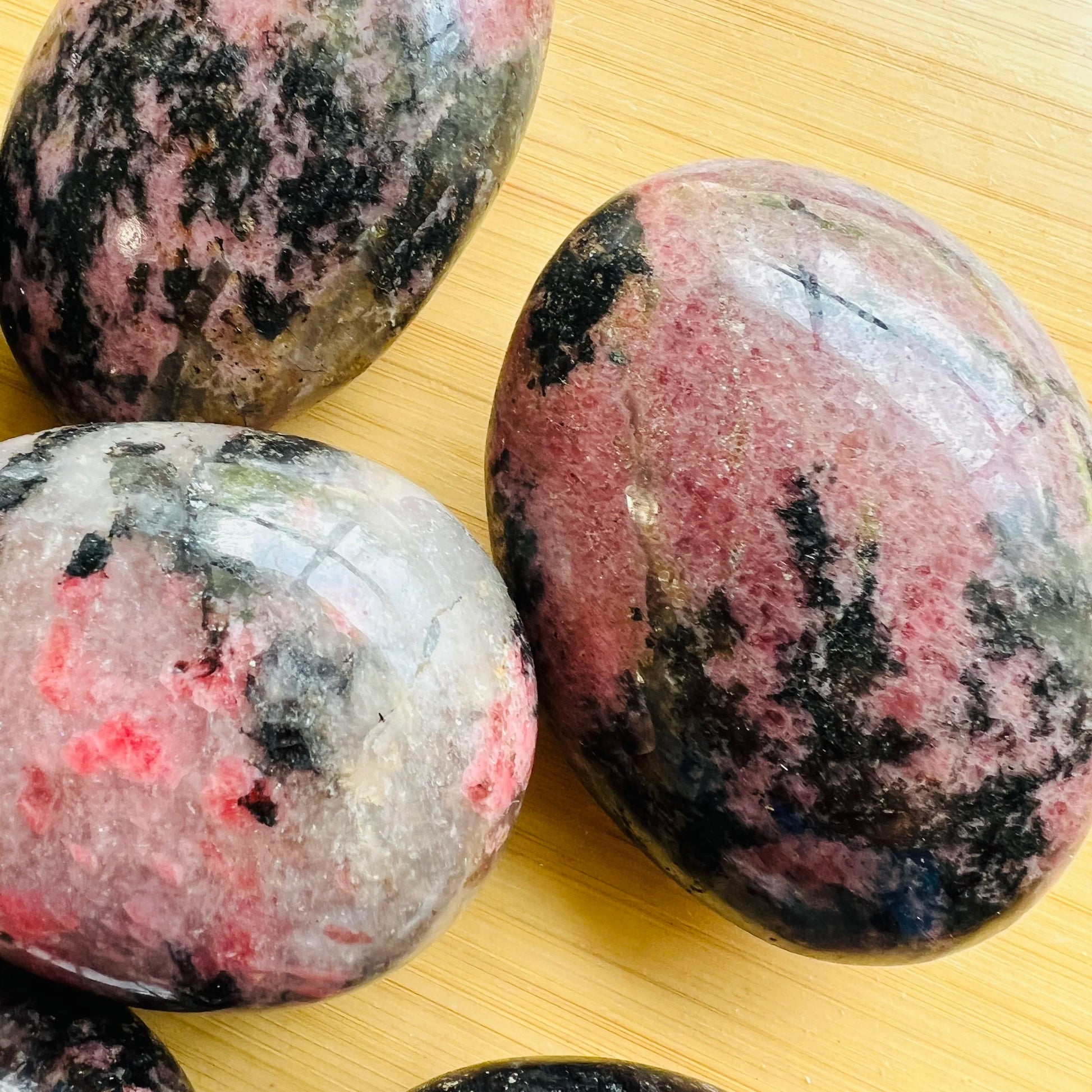 Full profile of Grade AA Rhodonite palm stone ready to ship from Beyond Bohemian