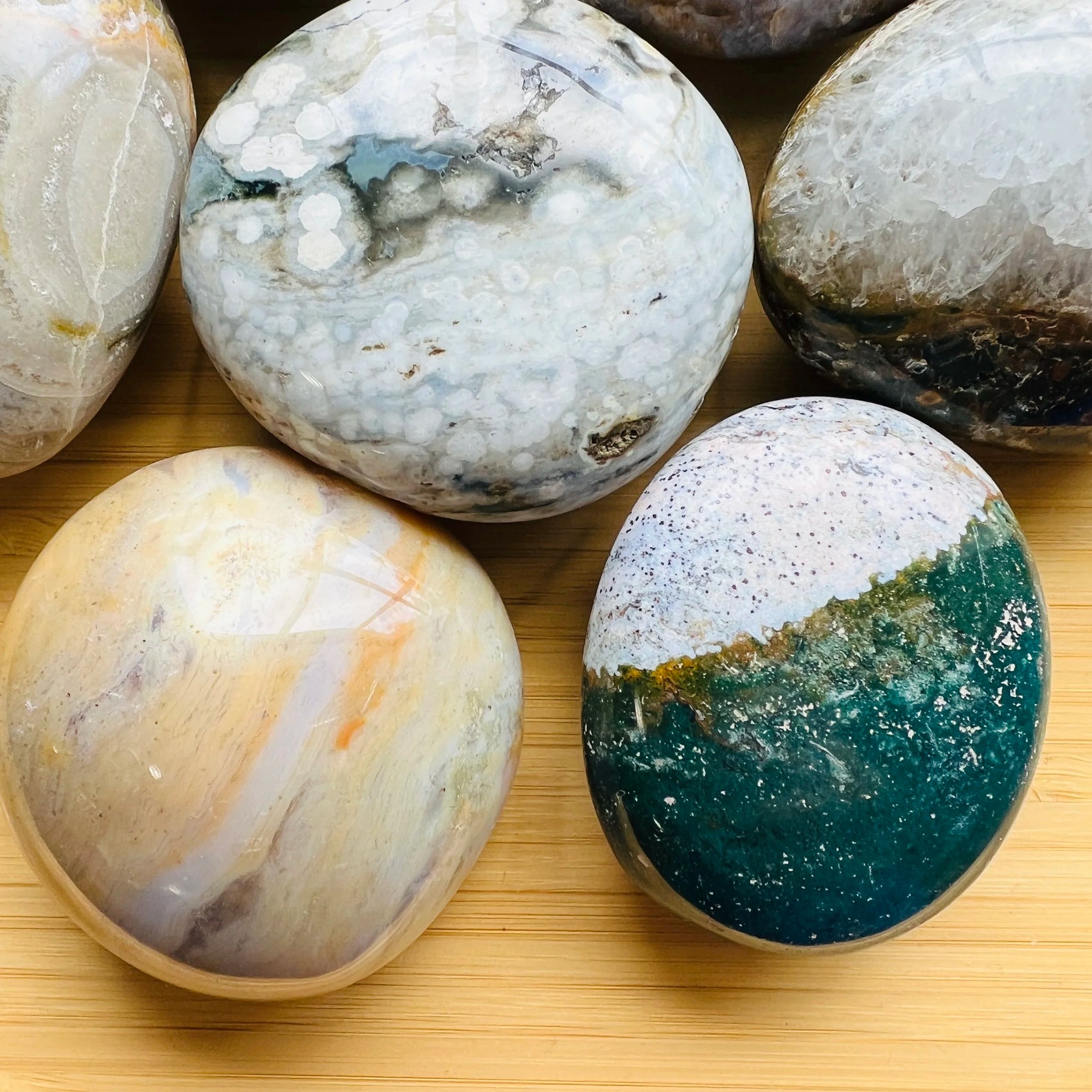Close-up of Grade AA Ocean Jasper palm stone, from Sofia, Madagascar, kept near for Emotional Healing and Stress Relief.