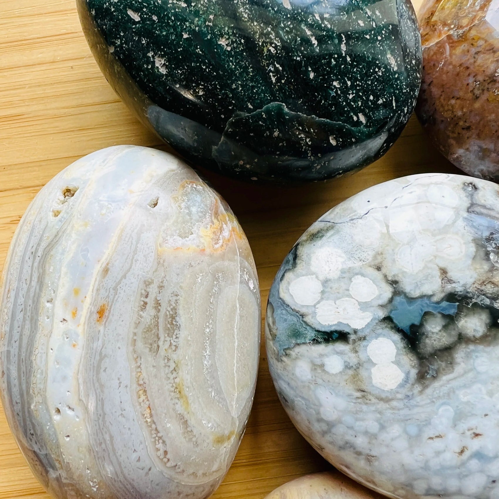 Lateral view of Ocean Jasper palm stone, hand-selected from Sofia, Madagascar, showing natural texture.