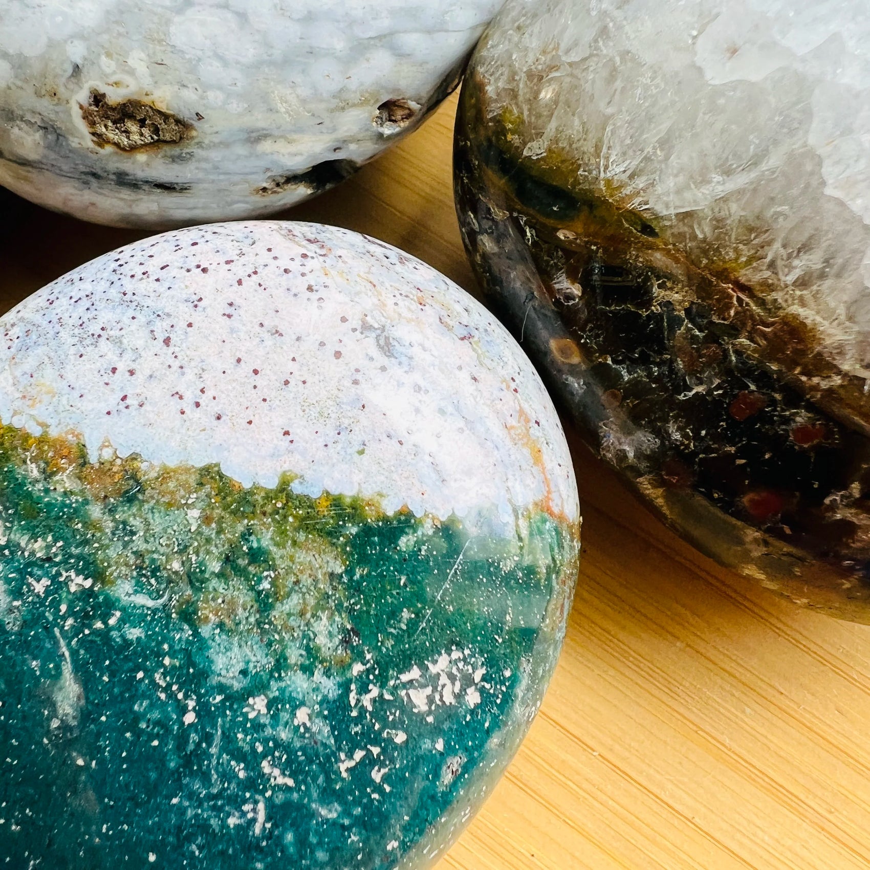Top-side view of green Ocean Jasper palm stone, traditionally used for Emotional Healing and Stress Relief.