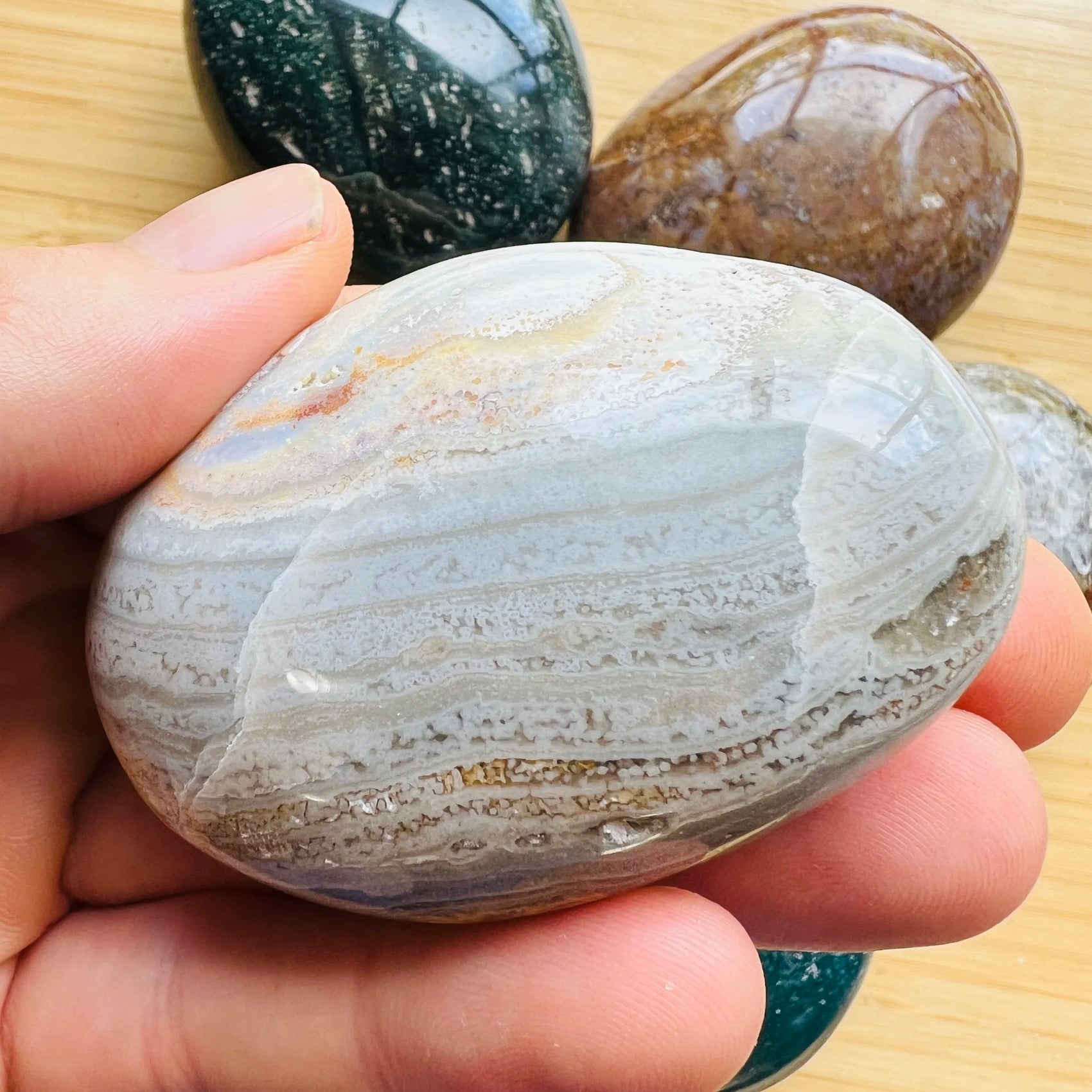 Palm-scale view of a Ocean Jasper palm stone, hand-selected from Sofia, Madagascar.
