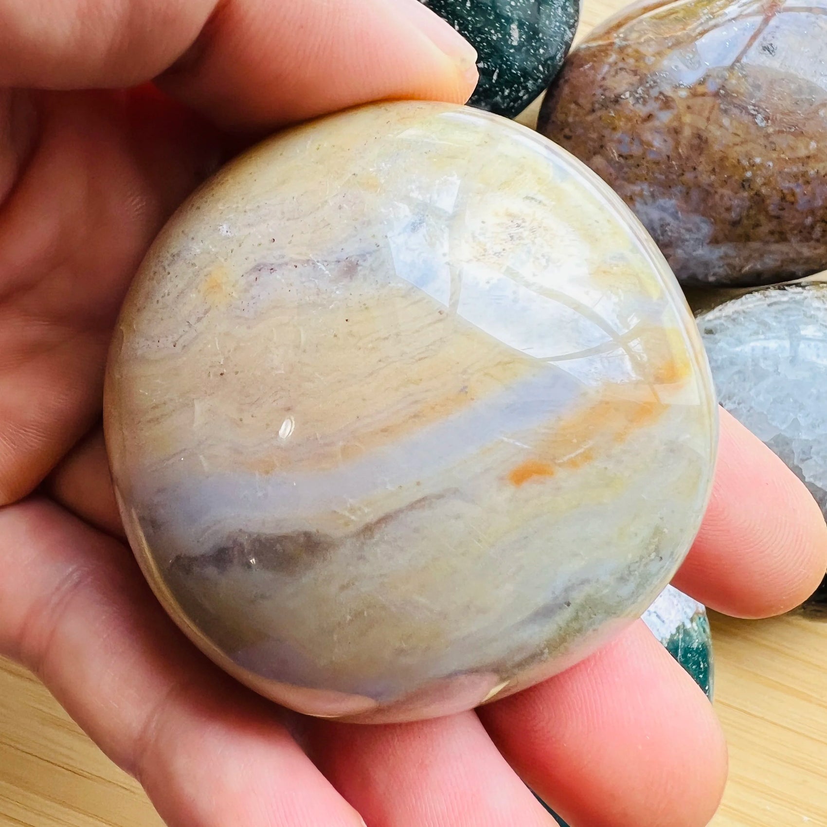 Soft-light view of Ocean Jasper palm stone, from Sofia, Madagascar, associated with Stress Relief, showing the wear and finish.