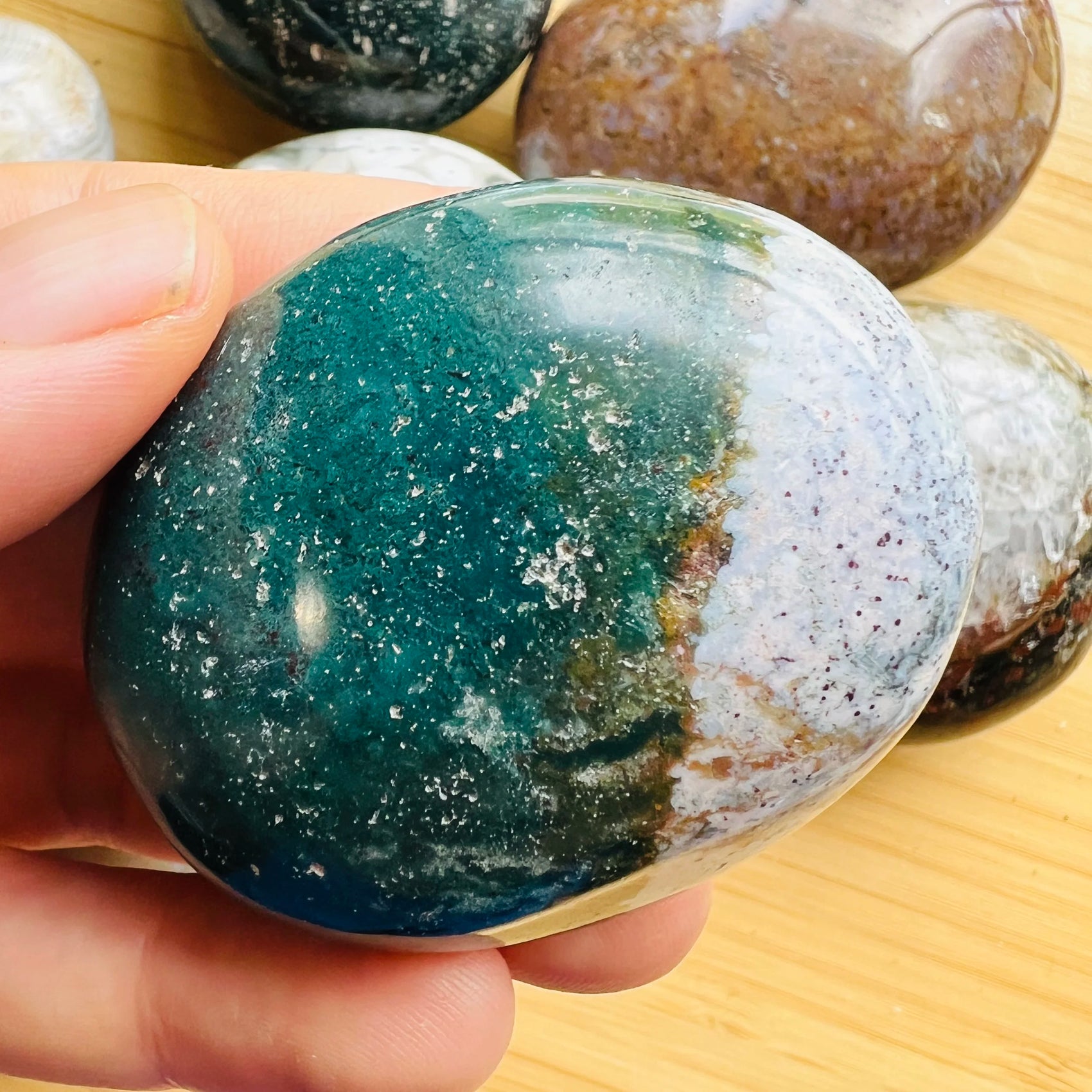 Back view of Grade AA Ocean Jasper palm stone showing natural surface