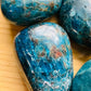Sideways view of Apatite palm stone, showing characteristic finish.