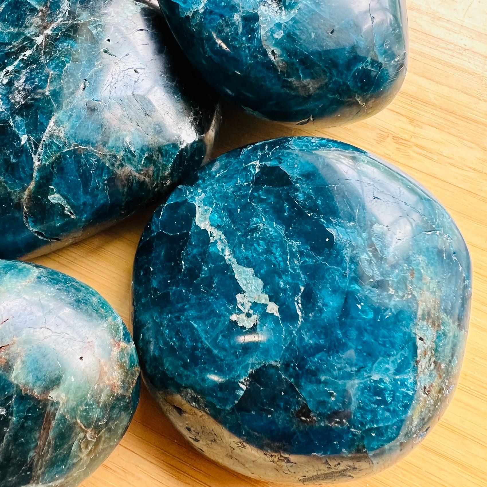 Underside view of blue Apatite palm stone, showing natural texture, Madagascar-sourced.