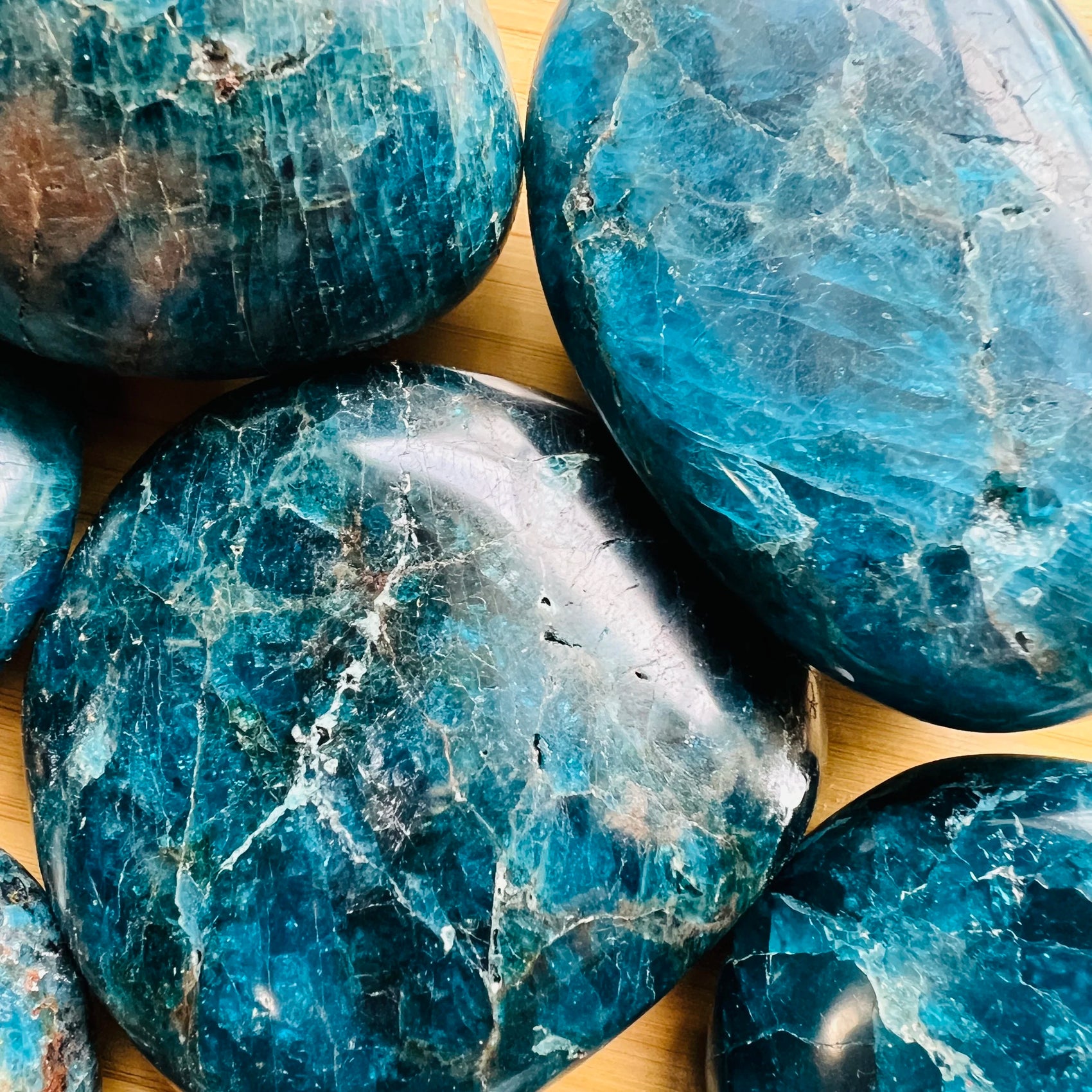 Scale reference of a Apatite palm stone held against natural backdrop, from Madagascar.