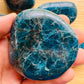 Companion image of Apatite palm stone, shown at hand scale.