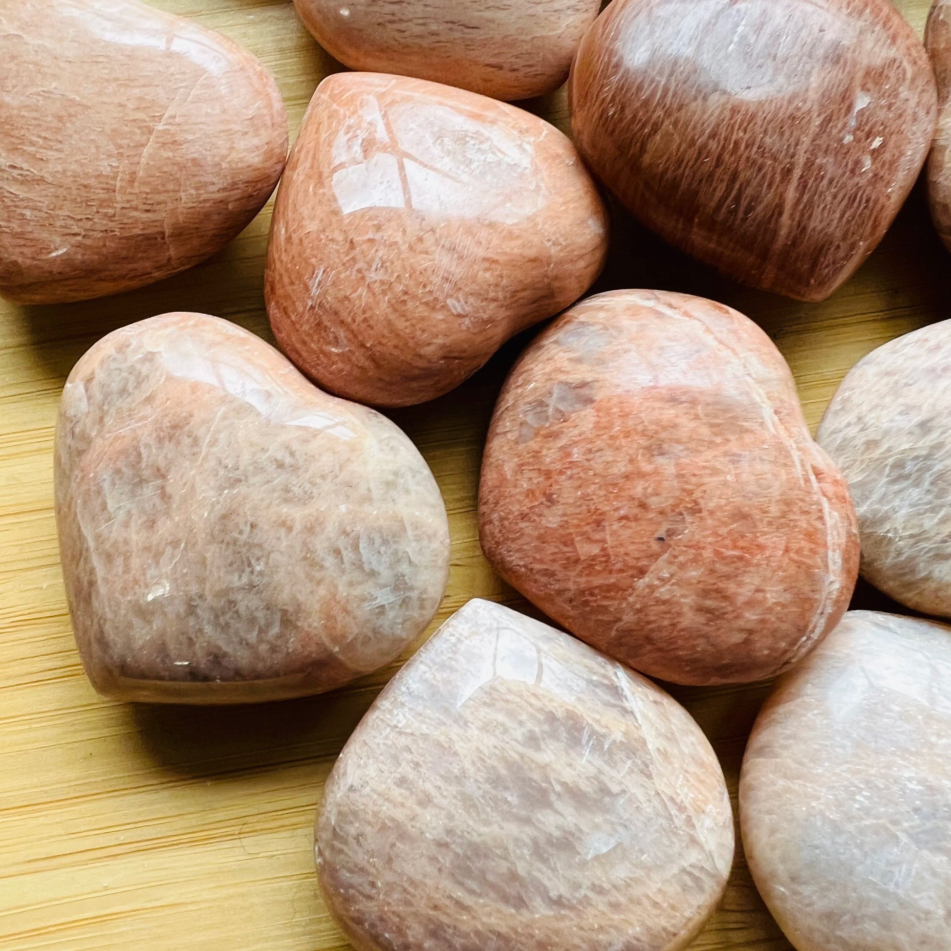 Reverse angle of Grade AA Peach Moonstone polished heart, showing natural variation.