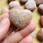 Detail shot of Grade AA Peach Moonstone heart under natural light