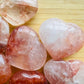 In-hand view of a Fire Quartz polished heart, from Madagascar.