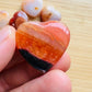 Detail shot of Grade AA Carnelian heart under natural light