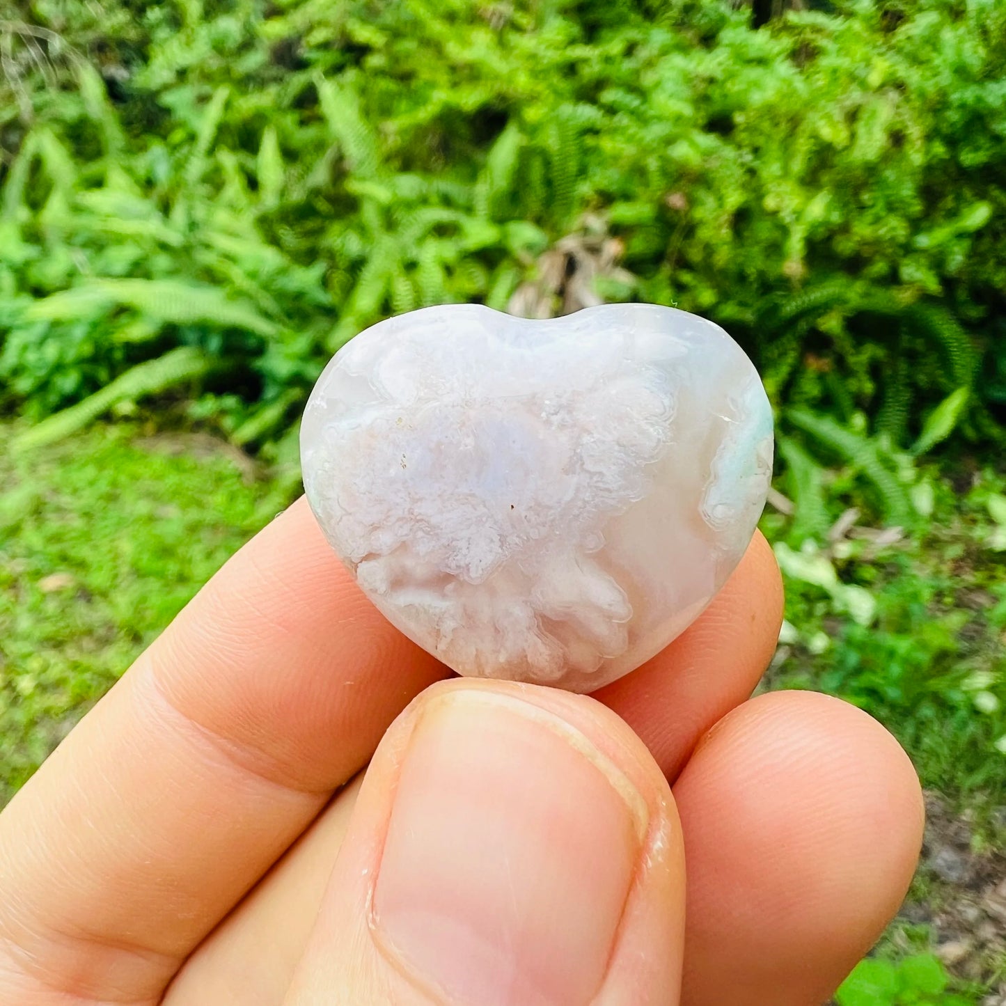 Edge view of Flower Agate polished heart, from Madagascar, carried for Love and Emotional Healing.